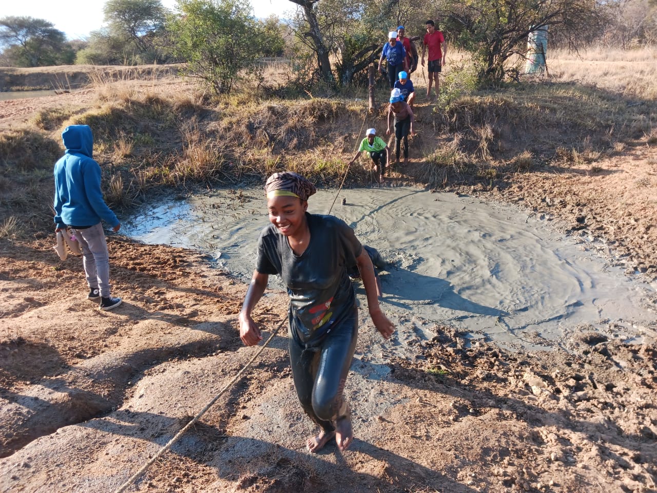 Students climbing rope ladder during team challenge